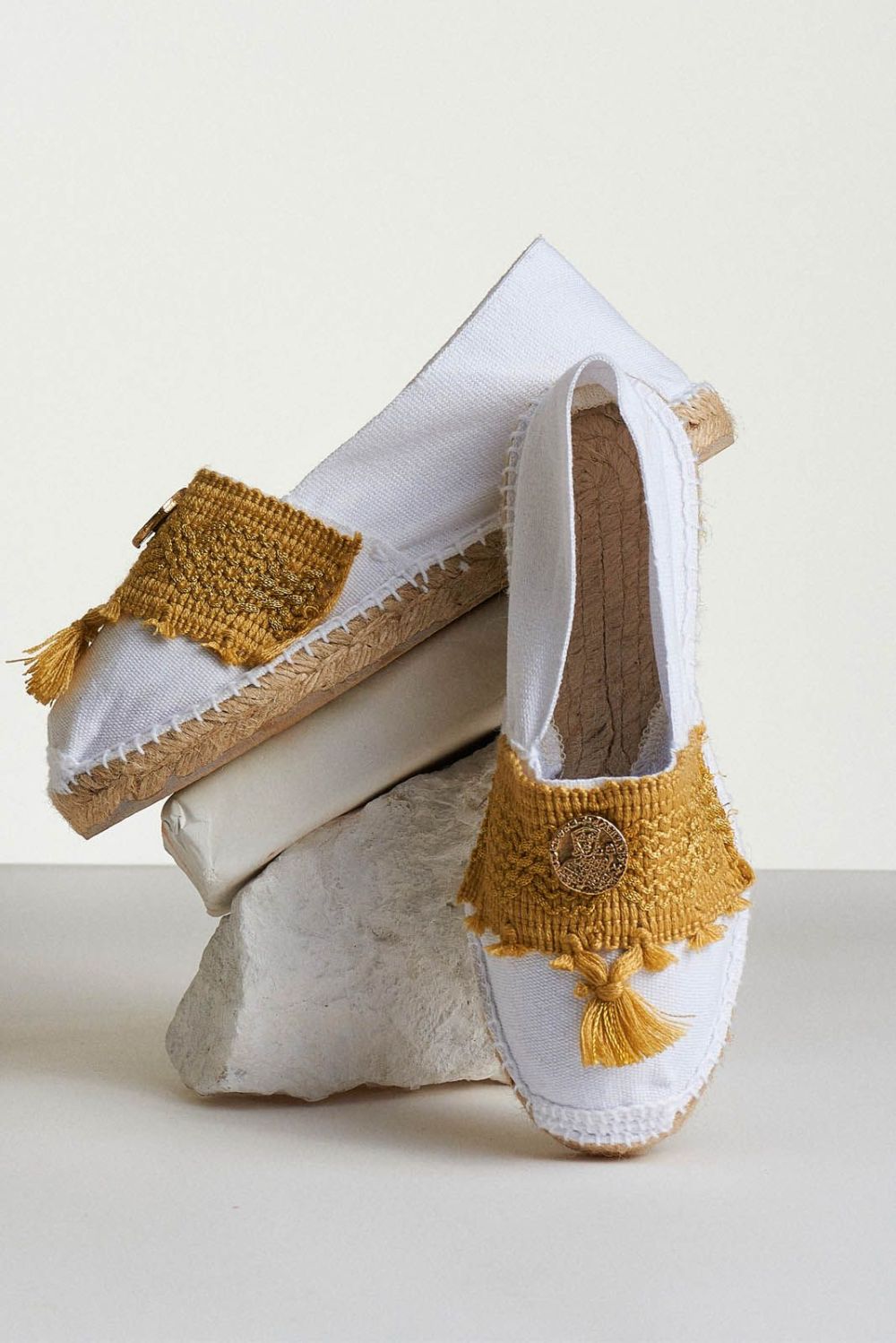 white espadrilles with ochre tassels and coin