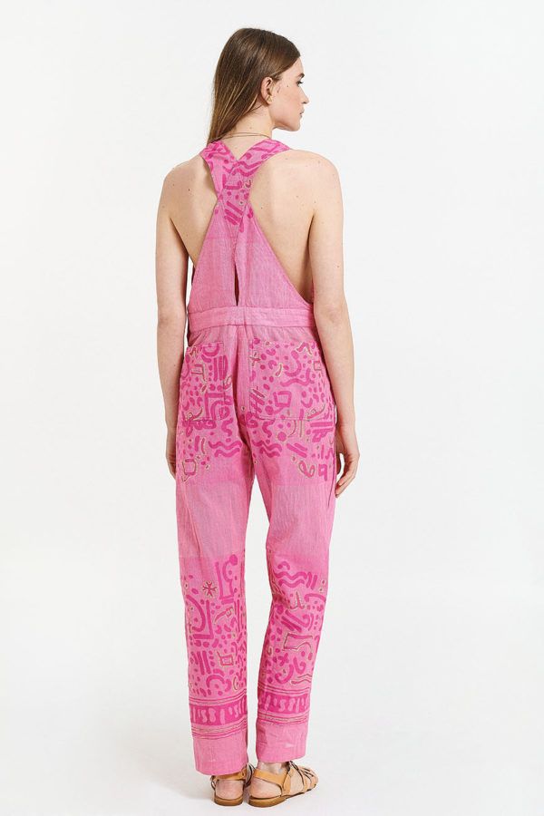unisex utility jumpsuit is pink with suspenders
