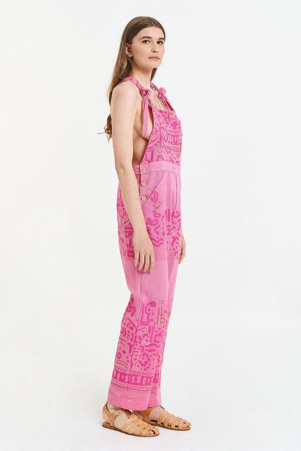 unisex utility jumpsuit is pink with suspenders