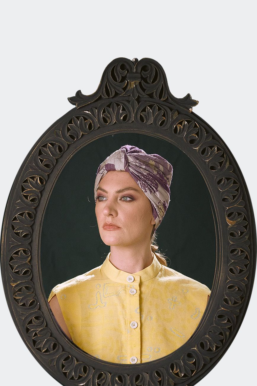 Portrait of a model wearing a mauve patterned luxury headpiece, turban