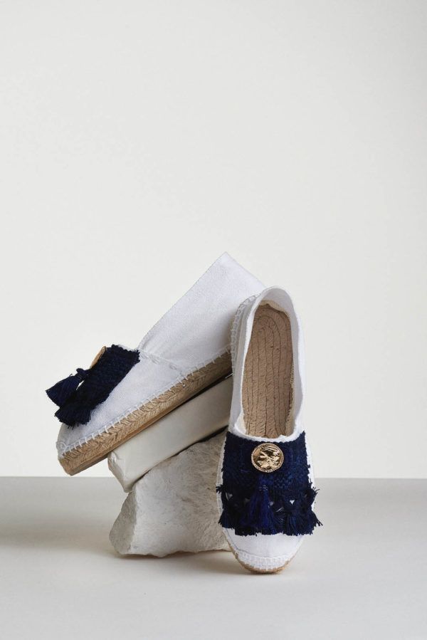 white espadrilles with blue tassels and coin