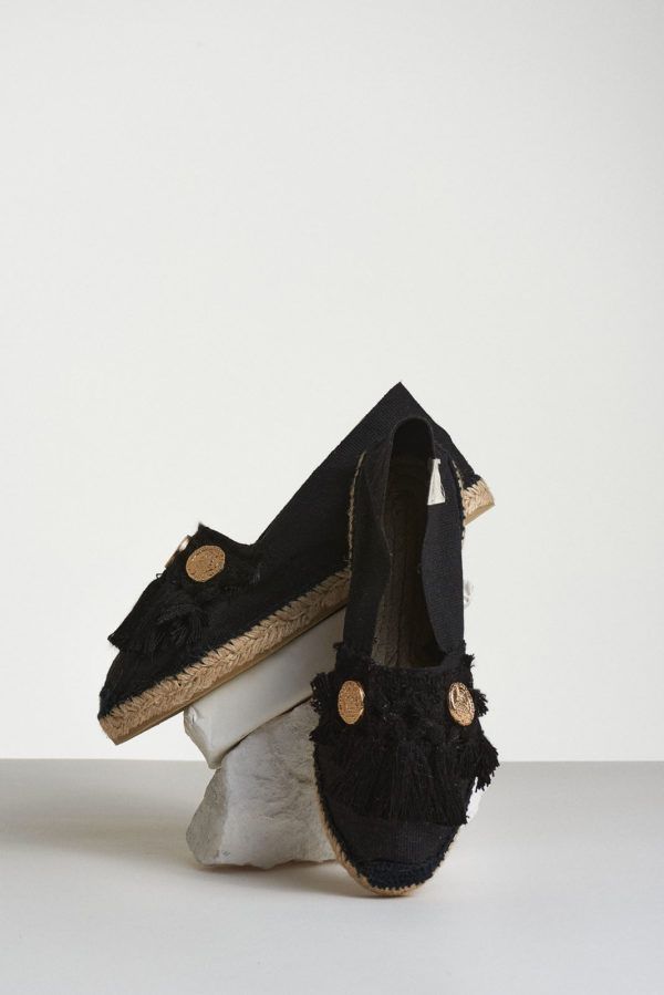 Black espadrilles with black tassels and four coins