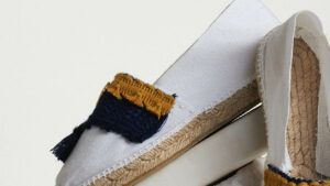 White espadrilles with blue-yellow tassels and coins